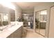 Modern bathroom with double vanity, glass shower, and stylish fixtures at 320 Clearbrook Cir # 203, Venice, FL 34292