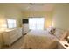 Cozy bedroom with floral bedding, ample natural light, and a serene ambiance at 320 Clearbrook Cir # 203, Venice, FL 34292
