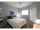 Cozy bedroom featuring a queen-size bed, neutral walls, and a ceiling fan at 320 Clearbrook Cir # 203, Venice, FL 34292