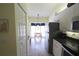 View of the kitchen featuring stainless steel appliances and an open dining area at 320 Clearbrook Cir # 203, Venice, FL 34292
