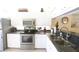 Updated kitchen with stainless steel appliances, granite countertops, and white cabinetry at 320 Clearbrook Cir # 203, Venice, FL 34292