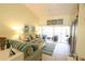 Bright living room features comfortable sofas with balcony access at 320 Clearbrook Cir # 203, Venice, FL 34292