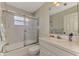 Cozy bathroom featuring a shower-tub combo with sliding glass doors and a white vanity at 331 Bucknell Rd, Venice, FL 34293