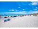Beautiful beach scene featuring white sands, clear blue skies, and beachgoers enjoying a sunny day at 331 Bucknell Rd, Venice, FL 34293