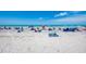 Scenic beach view with beachgoers, umbrellas, and clear ocean water, perfect for a relaxing day by the sea at 331 Bucknell Rd, Venice, FL 34293
