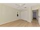 Bedroom with light wood floors, ceiling fan, and view of the closet at 331 Bucknell Rd, Venice, FL 34293