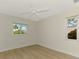 Bright bedroom with hardwood flooring and two windows bringing in natural light at 331 Bucknell Rd, Venice, FL 34293
