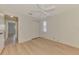 This bedroom has wood-look floors, a ceiling fan, closet, and an adjacent hallway visible at 331 Bucknell Rd, Venice, FL 34293