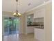 Bright dining room features sliding glass doors to the lanai and views into the breakfast bar at 331 Bucknell Rd, Venice, FL 34293