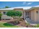 The cozy front entrance features a well-manicured garden and a sunny spot for plants at 331 Bucknell Rd, Venice, FL 34293