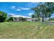 Charming home featuring a lush green lawn and a durable metal roof; a large shade tree is a bonus at 331 Bucknell Rd, Venice, FL 34293