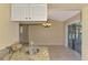 Kitchen with granite countertops and a view of a sunroom through sliding glass doors at 331 Bucknell Rd, Venice, FL 34293