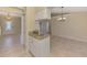 View of the kitchen island bar extending into the entryway and a dining area with a chandelier at 331 Bucknell Rd, Venice, FL 34293