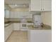 Clean kitchen featuring white cabinets, granite countertops, tile flooring and modern appliances at 331 Bucknell Rd, Venice, FL 34293