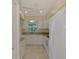 Bright and airy kitchen featuring white cabinets and appliances, granite counters, and a ceiling fan at 331 Bucknell Rd, Venice, FL 34293