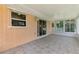 The covered lanai features sliding glass doors, a ceiling fan, and access to the sunroom at 331 Bucknell Rd, Venice, FL 34293