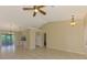 Large open living space features neutral colors, tile flooring, and views into the kitchen and lanai at 331 Bucknell Rd, Venice, FL 34293
