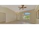 This bright and airy living room features tile flooring, a ceiling fan, and views of the front yard at 331 Bucknell Rd, Venice, FL 34293