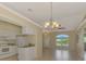 Spacious living area seamlessly connecting to the kitchen, featuring tile flooring and lots of natural light at 331 Bucknell Rd, Venice, FL 34293
