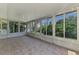 Bright sunroom featuring many windows offering views of the yard, a ceiling fan, and tile floors at 331 Bucknell Rd, Venice, FL 34293