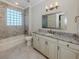 Well-lit bathroom featuring a bathtub, toilet, and a vanity with granite countertop at 333 Sunrise Dr, Nokomis, FL 34275