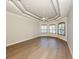 Spacious bedroom with beautiful wood floors, tray ceiling, and large windows with plantation shutters at 333 Sunrise Dr, Nokomis, FL 34275