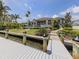 Beautiful waterfront property featuring a private dock and lush landscaping at 333 Sunrise Dr, Nokomis, FL 34275