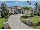 Beautiful home exterior featuring a circular driveway and lush landscaping at 333 Sunrise Dr, Nokomis, FL 34275