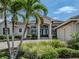 Beautifully landscaped home with a circular driveway and a three-car garage at 333 Sunrise Dr, Nokomis, FL 34275