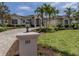 Well-manicured front lawn and garden with a charming entryway and a three-car garage at 333 Sunrise Dr, Nokomis, FL 34275