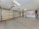 Spacious three-car garage with epoxy floors, storage cabinets, and updated garage door openers at 333 Sunrise Dr, Nokomis, FL 34275