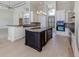 A spacious kitchen features an island with a beverage cooler, granite countertops, and modern appliances at 333 Sunrise Dr, Nokomis, FL 34275