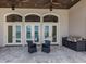 Large patio with travertine flooring and a built-in outdoor kitchen and bar, great for entertaining at 333 Sunrise Dr, Nokomis, FL 34275
