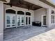 Large patio with travertine flooring and a built-in outdoor kitchen and bar at 333 Sunrise Dr, Nokomis, FL 34275