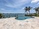 Beautiful kidney shaped pool overlooking the bay and framed by lush, tropical palm trees at 333 Sunrise Dr, Nokomis, FL 34275