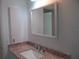 Updated bathroom featuring a granite countertop vanity and framed mirror at 334 Dante Dr # 334, Nokomis, FL 34275