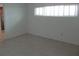 Clean bedroom featuring tile floors, a window with blinds, and ensuite bathroom access at 334 Dante Dr # 334, Nokomis, FL 34275