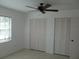 Well-lit bedroom features tile floors, a window with blinds, and double door closets at 334 Dante Dr # 334, Nokomis, FL 34275