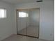 Bright bedroom with large mirrored closet reflecting natural light at 334 Dante Dr # 334, Nokomis, FL 34275