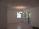Bright dining area featuring tile floors, chandelier, and sliding glass doors with plantation shutters at 334 Dante Dr # 334, Nokomis, FL 34275