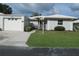 Charming single-story home with a well-manicured lawn, light grey paint, and white trim at 334 Dante Dr # 334, Nokomis, FL 34275