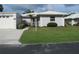 Charming single-story home with a well-manicured lawn, light grey paint, and white trim at 334 Dante Dr # 334, Nokomis, FL 34275