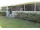The screened patio is accessible from the yard; bushes provide privacy at 334 Dante Dr # 334, Nokomis, FL 34275