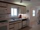 Well-lit kitchen with tile floors and standard appliances at 334 Dante Dr # 334, Nokomis, FL 34275