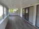 Relaxing covered lanai featuring wood flooring and walls of screens, providing great natural light at 334 Dante Dr # 334, Nokomis, FL 34275