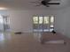 Spacious living room features tile flooring and sliding glass doors with plantation shutters, natural light at 334 Dante Dr # 334, Nokomis, FL 34275