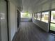 Enclosed sunroom with wood-look floors and multiple sliding windows at 334 Dante Dr # 334, Nokomis, FL 34275
