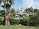 Waterfront view of boat docks framed by tropical palm trees on a sunny day at 334 Dante Dr # 334, Nokomis, FL 34275
