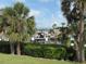Waterfront view of boat docks framed by tropical palm trees on a sunny day at 334 Dante Dr # 334, Nokomis, FL 34275