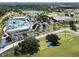 Aerial view of a community park with a pool, sports fields, and green spaces at 3588 Erie Ct, North Port, FL 34287